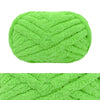 A ball of bright lime green hand-knitted wool finger line scarf yarn.