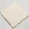 A square mat made of white plush material used for interlocking puzzles or rugs.