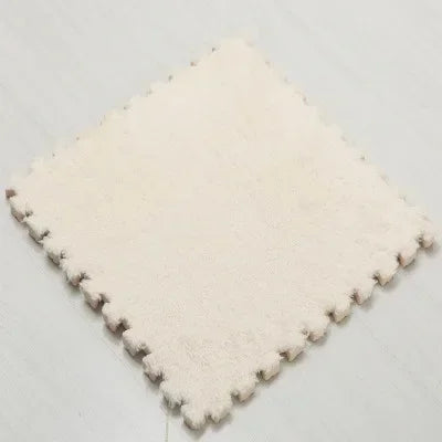 A square mat made of white plush material used for interlocking puzzles or rugs.