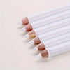 A row of white bamboo chalk pencils with natural colored tips laid diagonally on a light background.