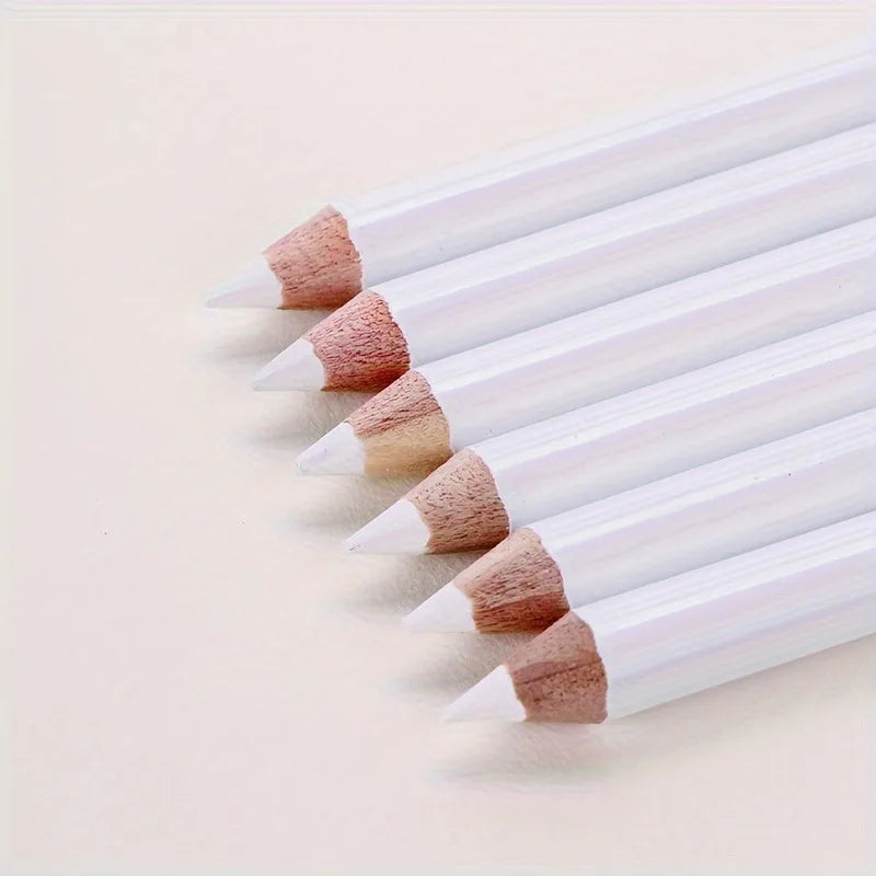 A row of white bamboo chalk pencils with natural colored tips laid diagonally on a light background.