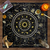 A dark fabric featuring a detailed astrological chart with zodiac signs and planetary symbols, surrounded by tarot elements.
