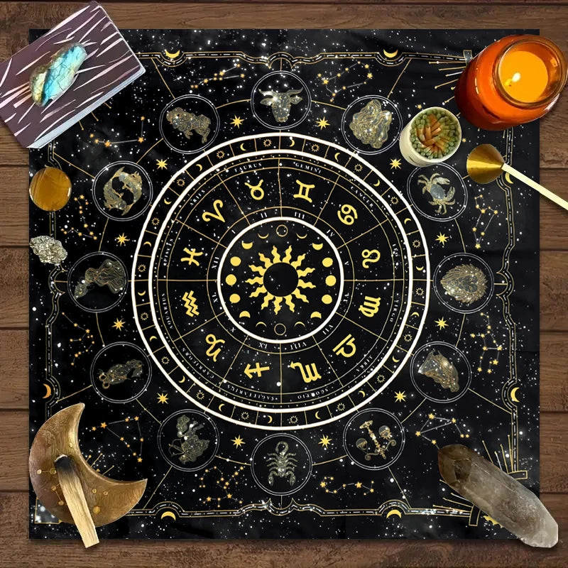 A dark fabric featuring a detailed astrological chart with zodiac signs and planetary symbols, surrounded by tarot elements.