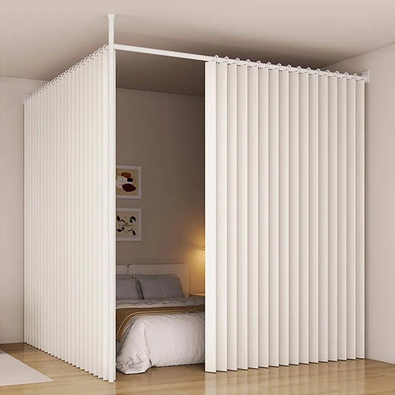 A white heavy duty foldable room divider curtain is shown in an open doorway, covering a bed area.