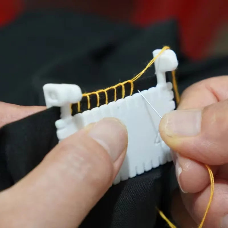 Hands are assembling a hinge-type fabric sewing guide with a measuring scale and yellow thread.