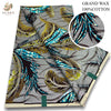 A roll of gray fabric featuring a pattern of black, yellow, and bright blue feather designs.