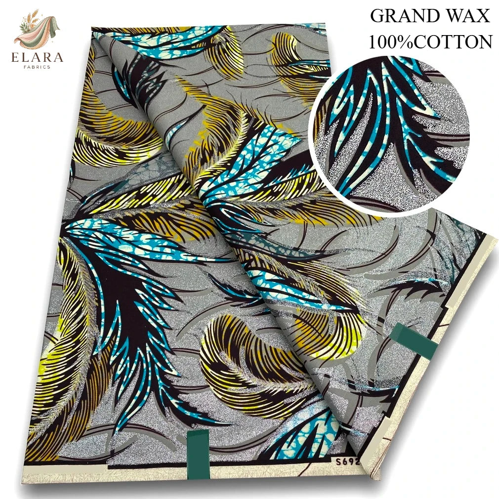 A roll of gray fabric featuring a pattern of black, yellow, and bright blue feather designs.