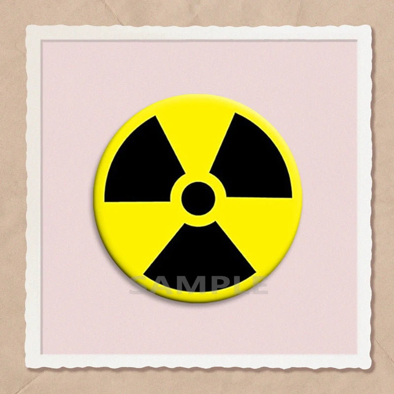 A yellow radiation symbol pin on a light pink background.
