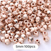 A pile of rose gold geometric acrylic beads, approximately 5mm in size, for jewelry making.