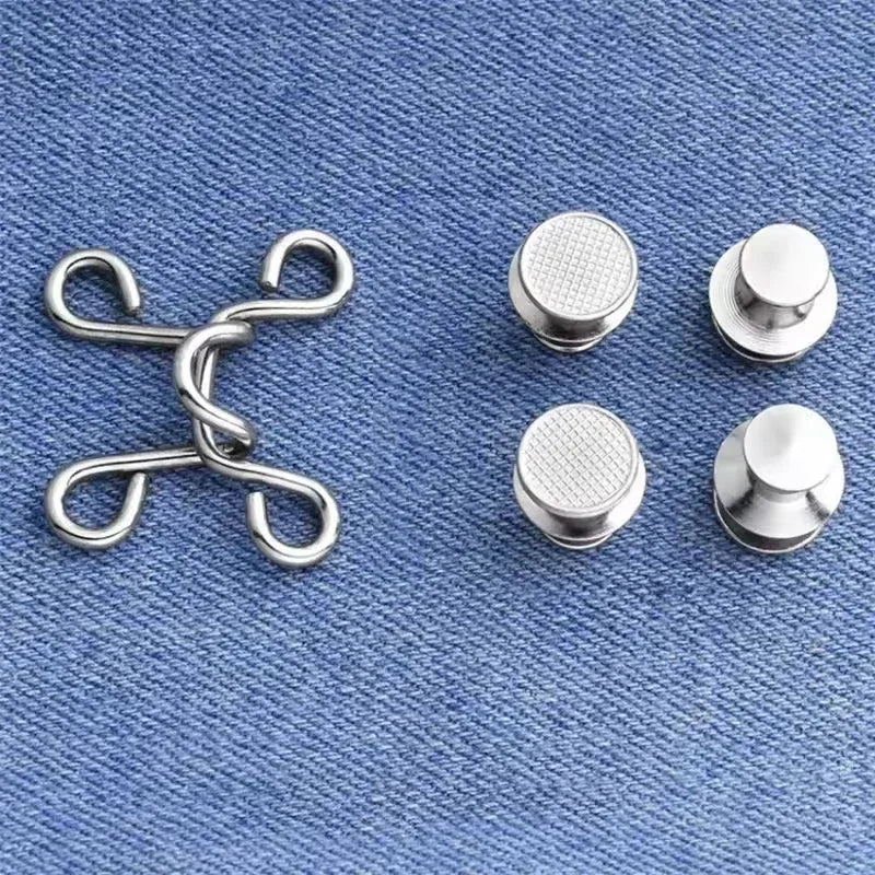 A collection of silver metal button snaps and clasps arranged on a blue denim fabric background.