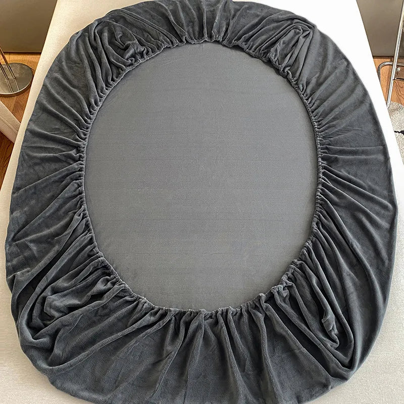 A circular gray velvet fabric drape or cover for bedding.
