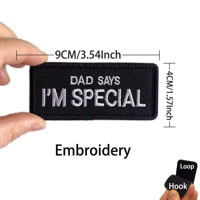 Black embroidered patch with white text that reads Dad says I'm special