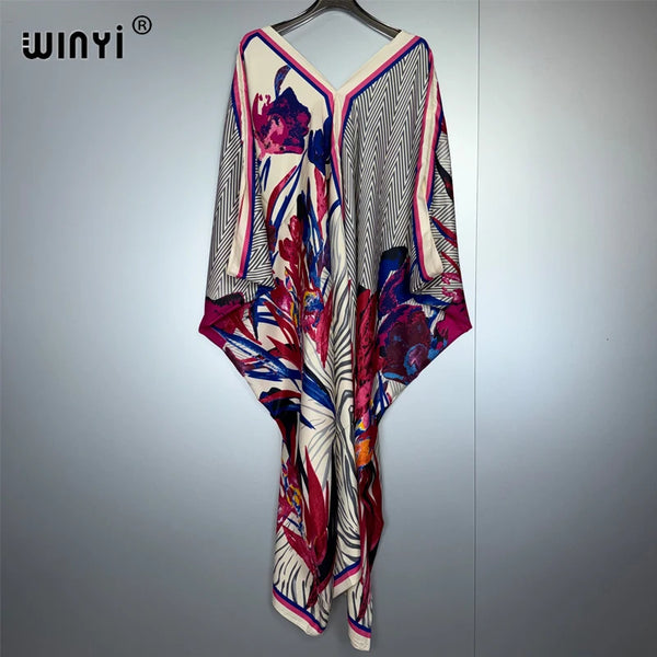 A long maxi dress featuring a bohemian floral print with pink, purple, and white patterns.