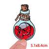 Embroidery patch depicting a rose skull inside a glass bottle with a cork stopper