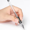 A hand is holding a clear glass pen with a black tip, demonstrating transparent silicone toe and finger protectors.