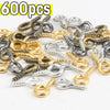 A pile of various silver and gold stainless steel eye screw pins for jewelry making.