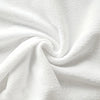 A close-up of a white plaid kitchen towel fabric, folded into a soft swirl.