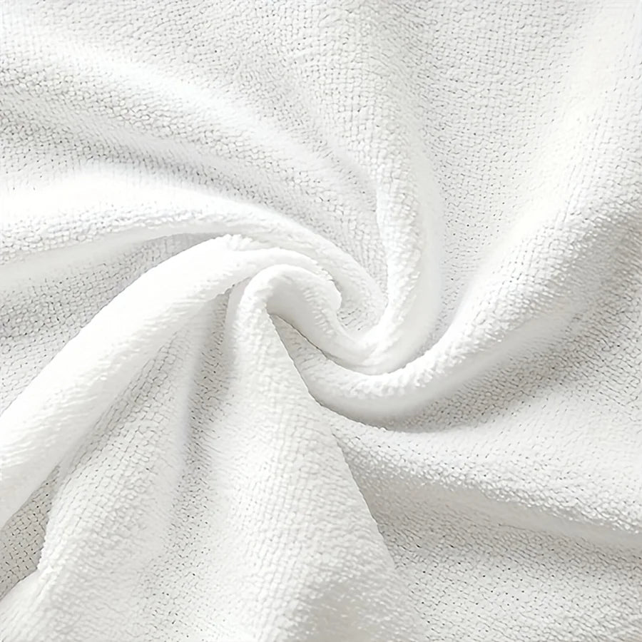 A close-up of a white plaid kitchen towel fabric, folded into a soft swirl.