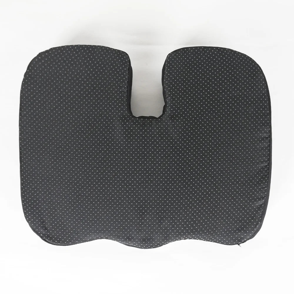 A gray ergonomic U-shaped massage seat cushion with a dotted pattern.