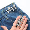 Silver adjustable waist clip brooches pinned onto blue denim fabric