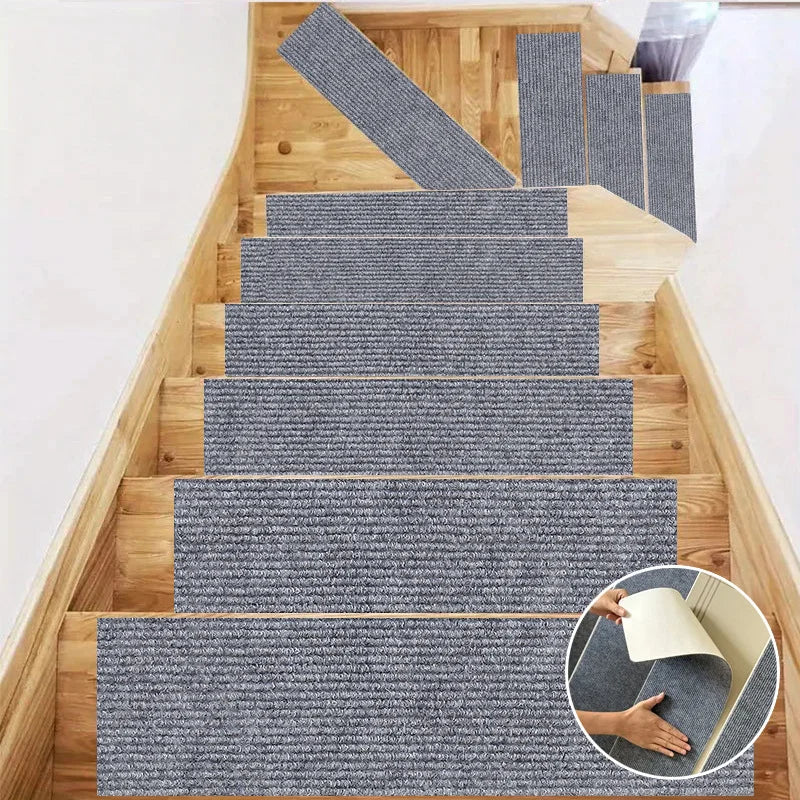 A set of self-adhesive gray textured mats installed on a wooden staircase and door frame.