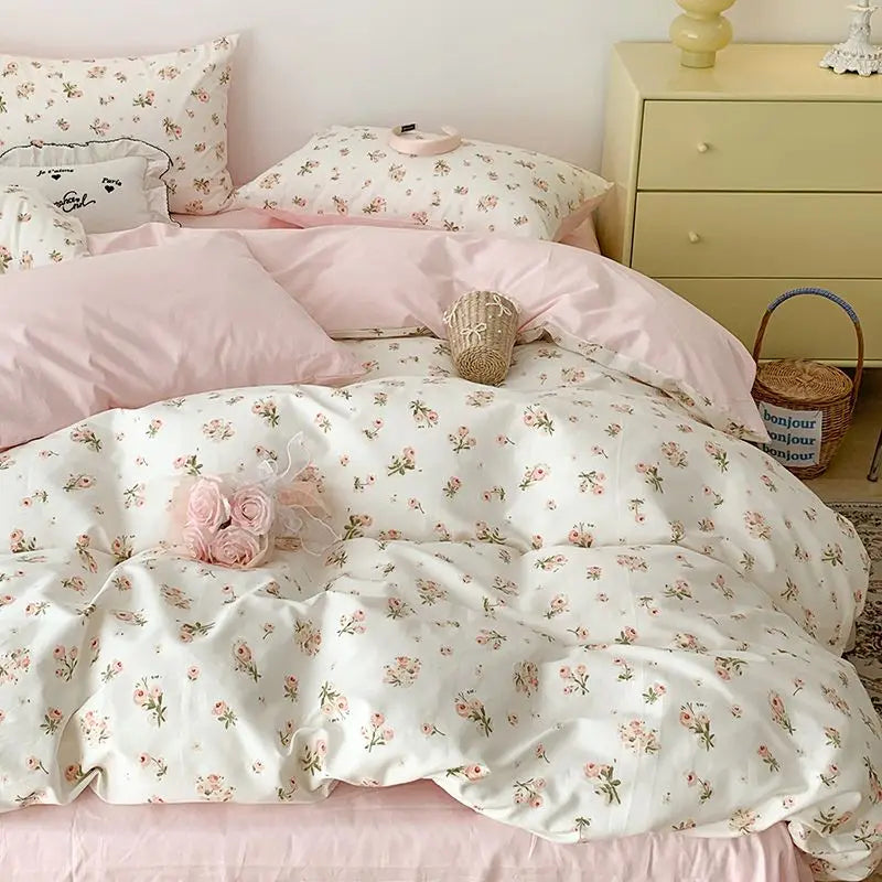 Pink floral bedding set featuring light pink and white patterns on a bed with matching pillows.