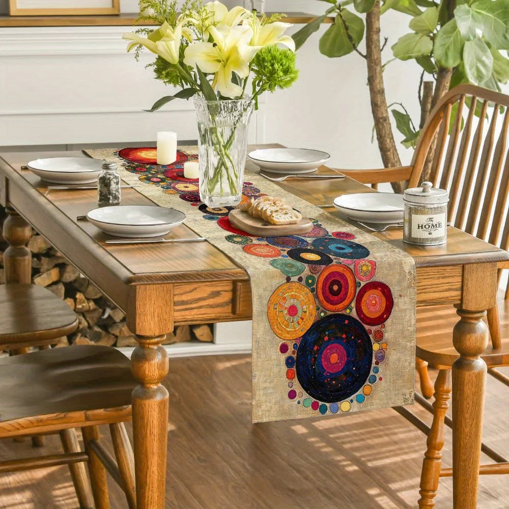 A bohemian polka dot table runner displayed on a wooden table with white plates and floral arrangements.