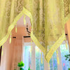 Elegant black lace curtain valance in lime green hangs over a window.