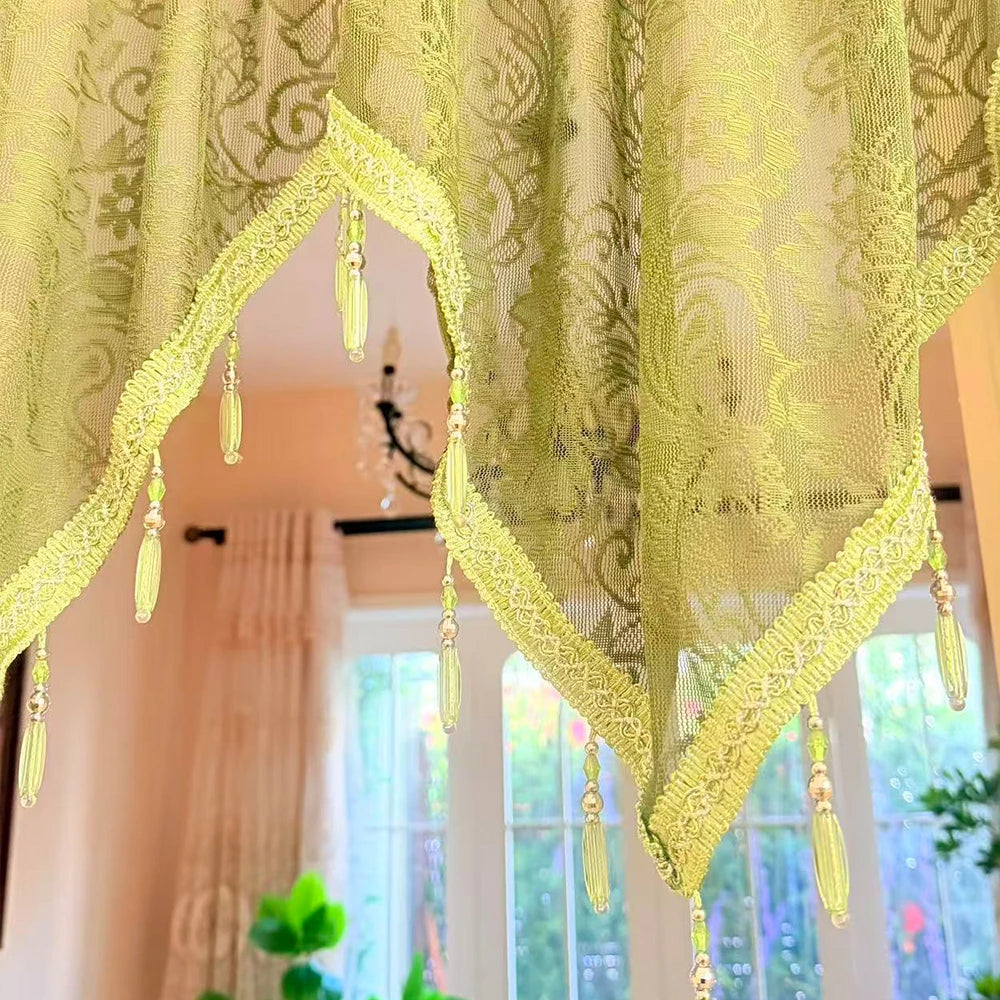 Elegant black lace curtain valance in lime green hangs over a window.
