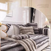 A plush velvet sofa protector cover in gray and beige textures is displayed on a white bed frame.