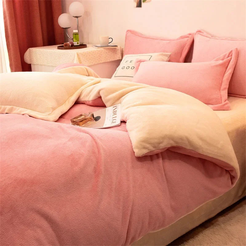 A pink and cream flannel duvet cover set displayed on a bed with pink pillows and a bedside table.