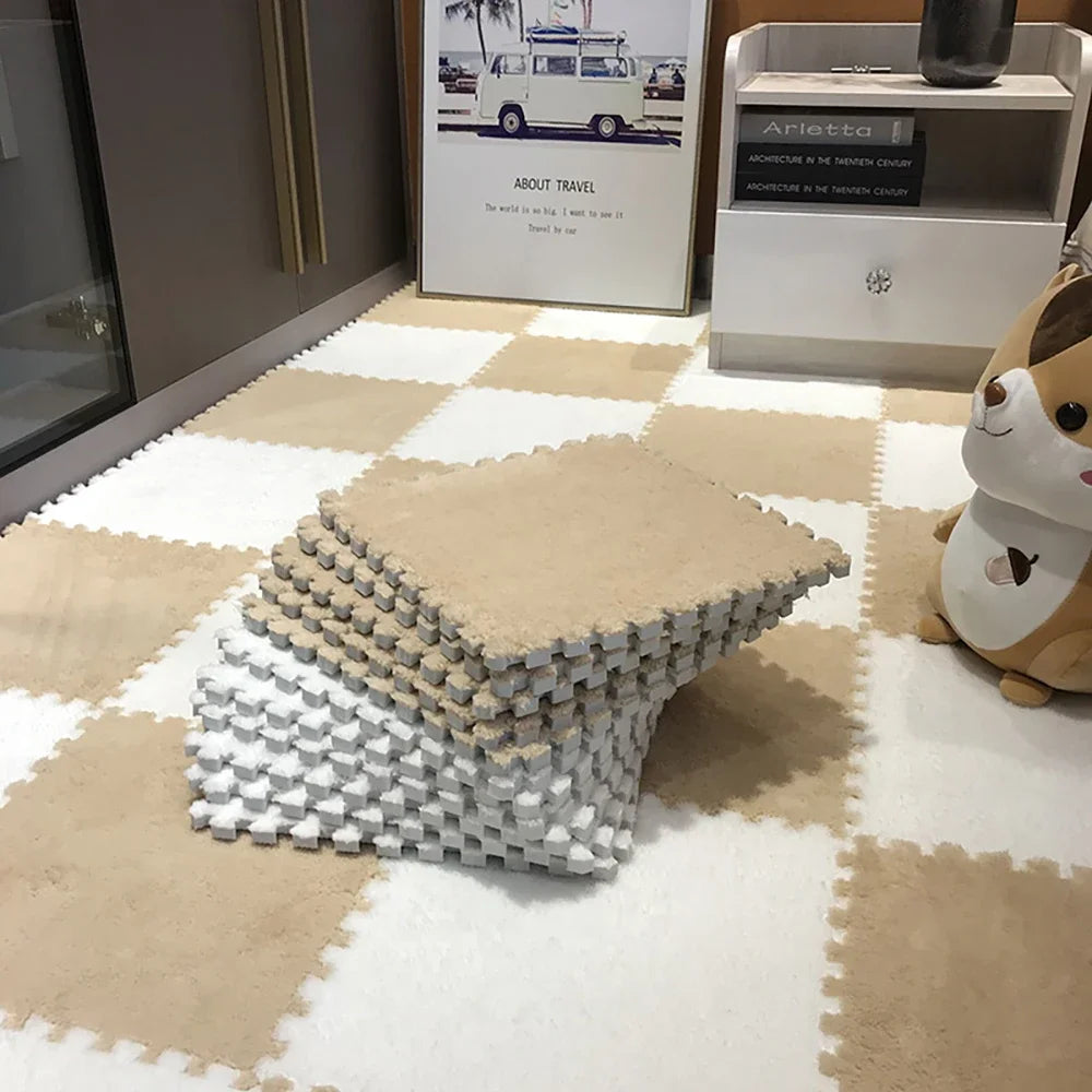 A stack of white and gray soft plush EVA foam play mat tiles on a beige tiled floor.
