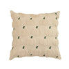 A beige fuzzy throw pillow cover with a repeating pattern of small green pumpkin shapes.