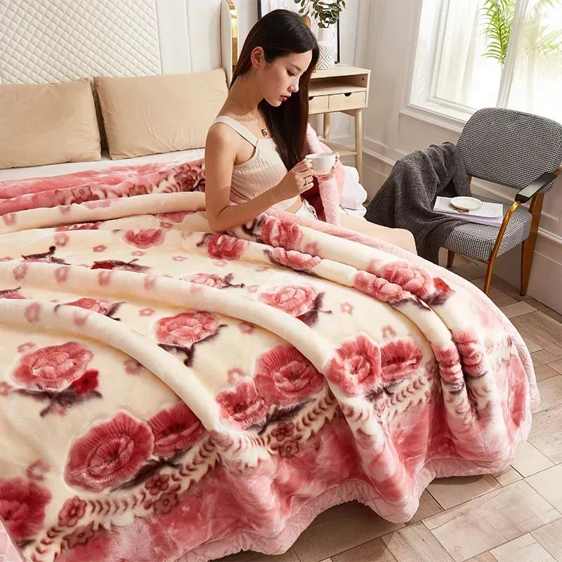 A pink and cream sherpa weighted blanket draped over a bed in a bright room.