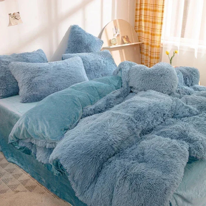 A fluffy blue mink velvet duvet set with matching pillows and a yellow plaid curtain in a bright room.