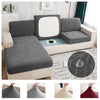 A waterproof jacquard stretch sofa cover in gray and white patterns shown on a modern sofa.