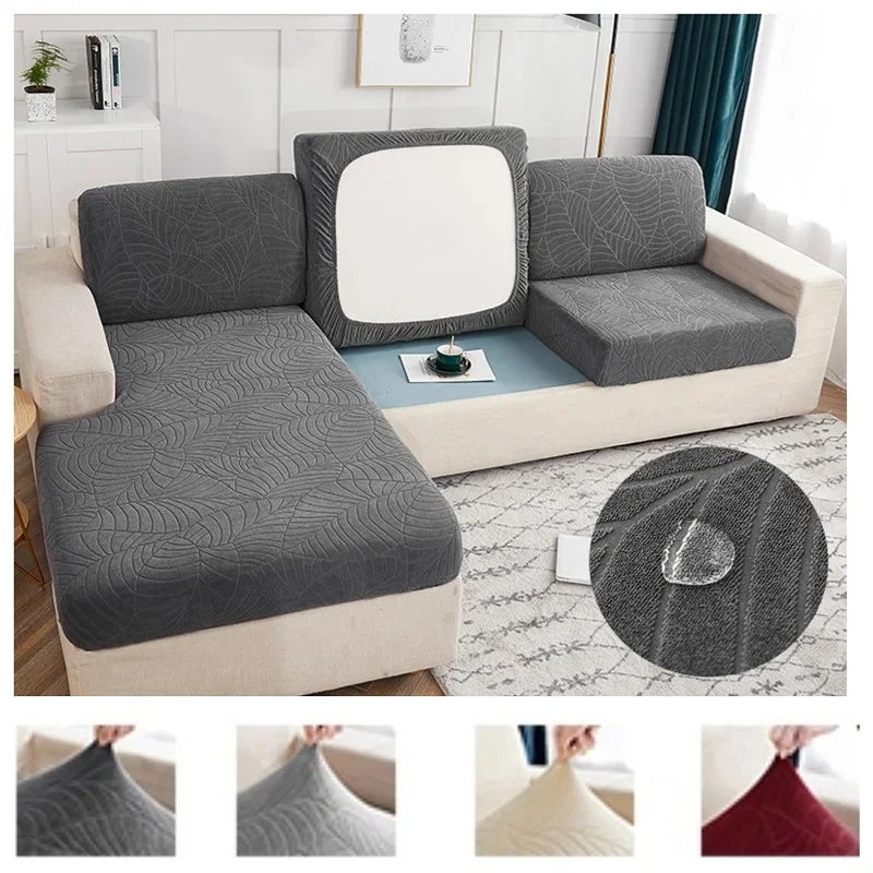 A waterproof jacquard stretch sofa cover in gray and white patterns shown on a modern sofa.