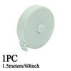 A light green retractable double-sided measurement tape with a clip.