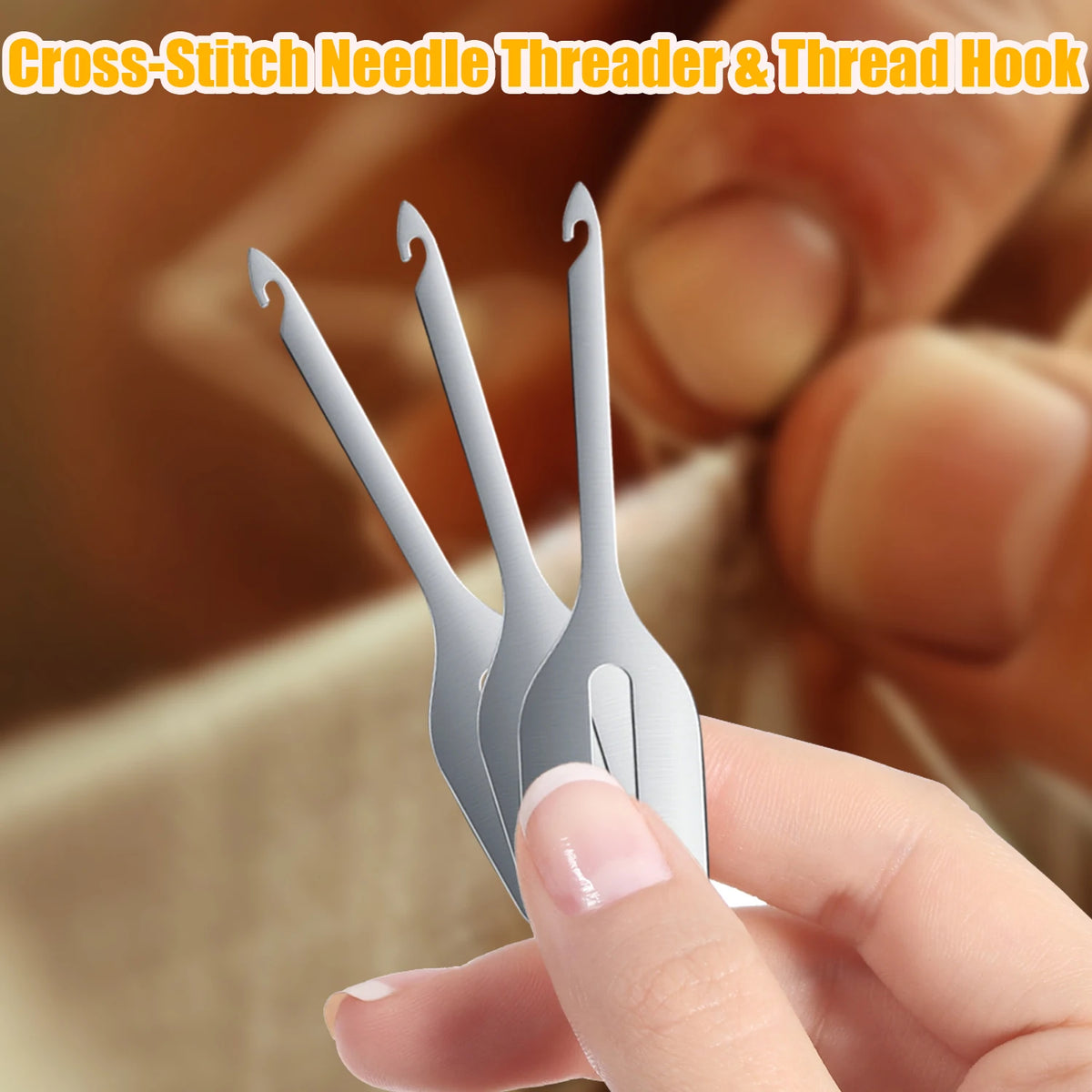 Stainless steel cross-stitch needle threader and hook tools held by a hand