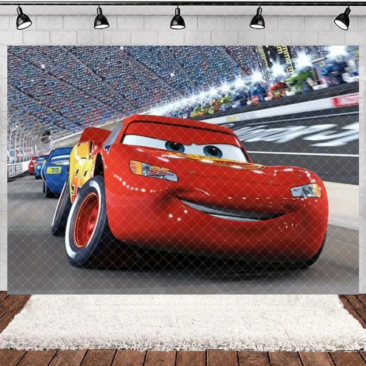 A red cartoon race car is featured in a dynamic shot against a blurred racetrack background.