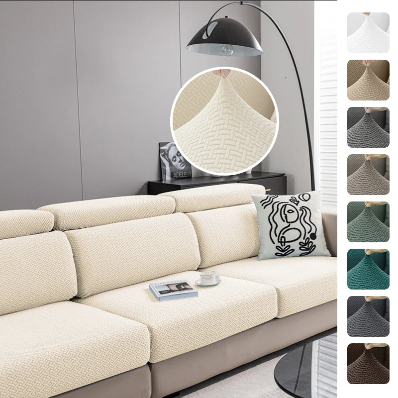 A beige jacquard knit sofa cushion cover displayed on a light gray sofa with a modern floor lamp.