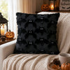 A black textured cushion cover featuring a repeating pattern of bat silhouettes used for Halloween decor.
