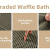 Close-up view of an upgraded waffle bath mat showing its soft resilient surface, clear rubber backing, and flexible texture.
