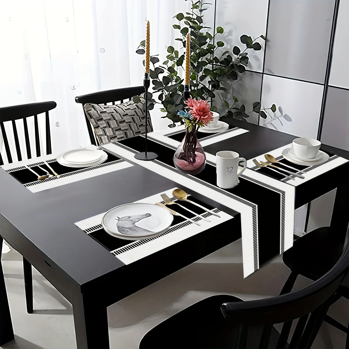 A black dining table set featuring a minimalist black and white placemat and table flag with cutlery and decorative elements.