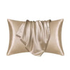 A luxurious champagne satin pillowcase draped elegantly.