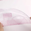 A precision sewing ruler set with French curve templates and a grid layout on a white surface.