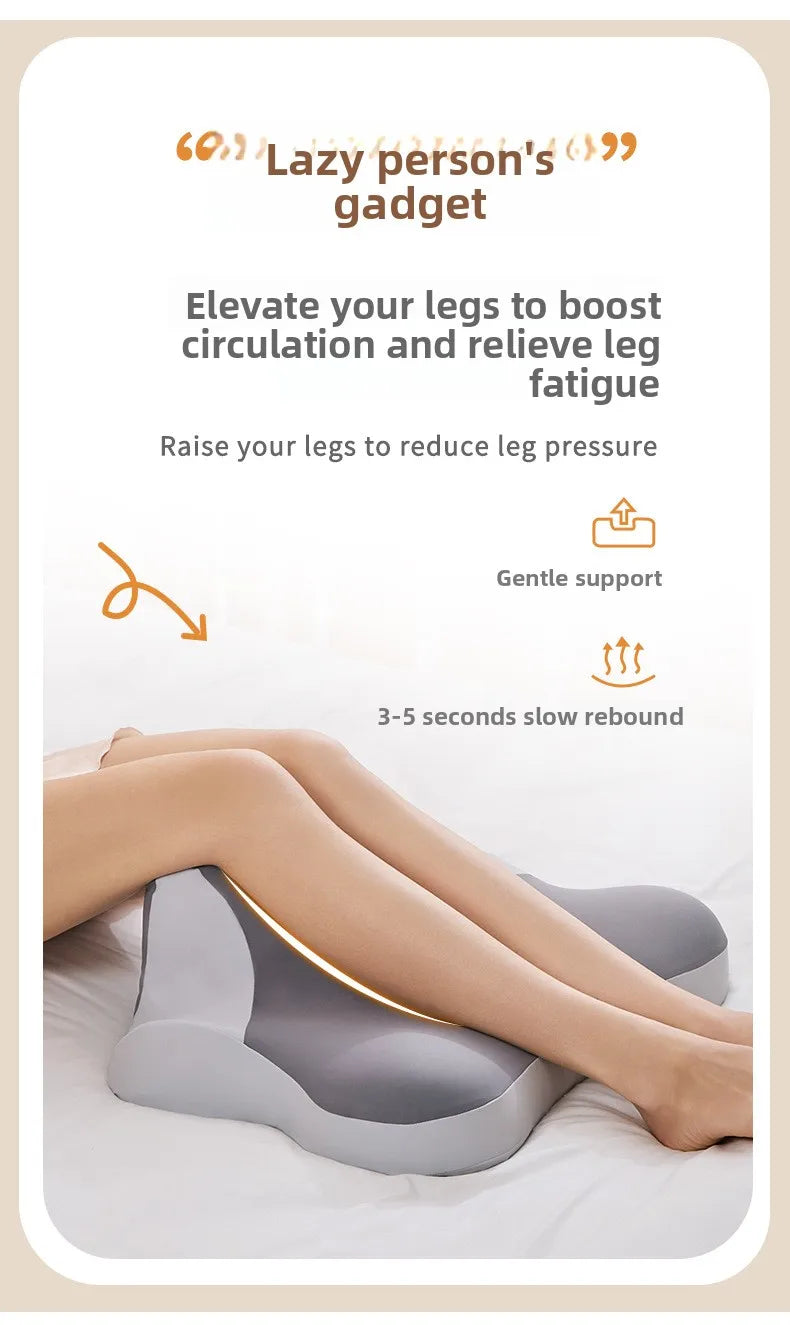 A person's legs are resting on a gray ergonomic wedge pillow designed to boost circulation and relieve fatigue.