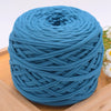 A ball of teal blue craft yarn for knitting and DIY displayed on a wooden surface.