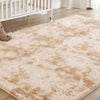A fluffy cream tie-dye shaggy rug placed on a light wood floor in a living room setting.
