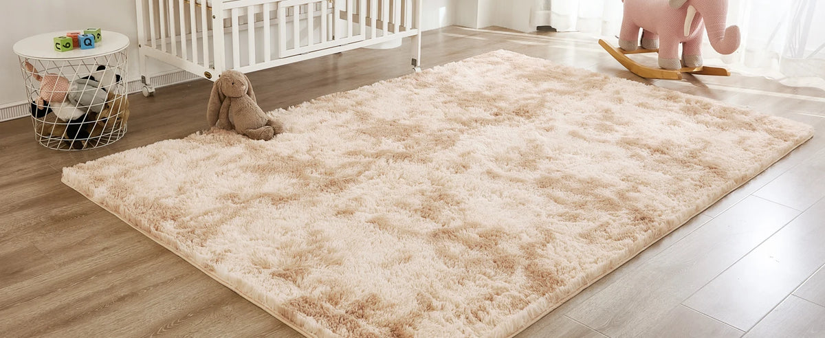 A fluffy cream tie-dye shaggy rug placed on a light wood floor in a living room setting.